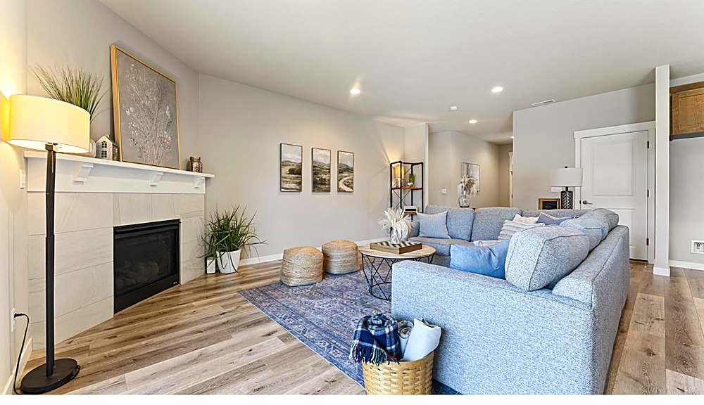 Open great room with gas fireplace and large windows