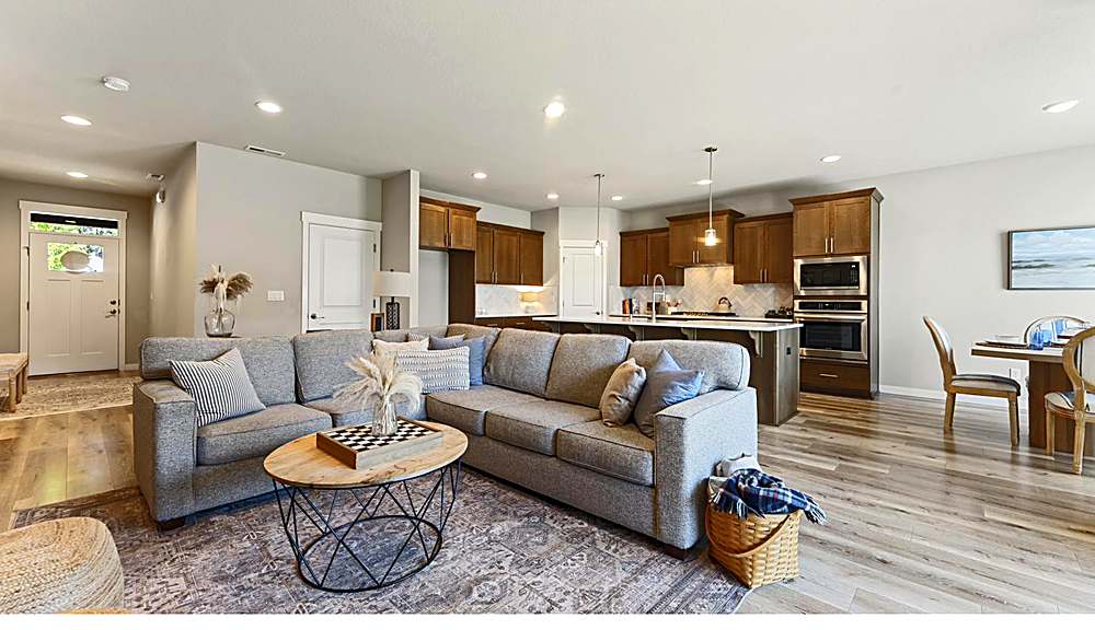 Open great room with gas fireplace and large windows