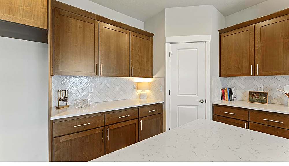 Kitchen with quartz counters, gas range and pantry