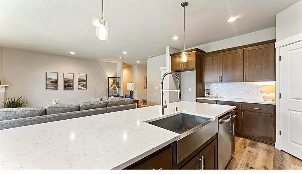 Kitchen with quartz counters, gas range and pantry
