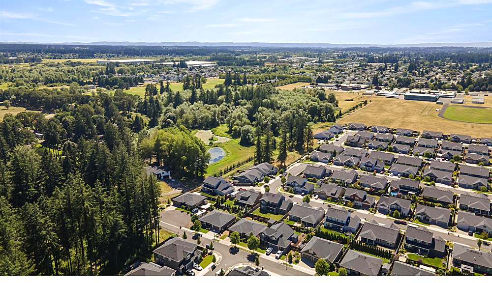 Aerial view of the home and the Orchards neighborhood
